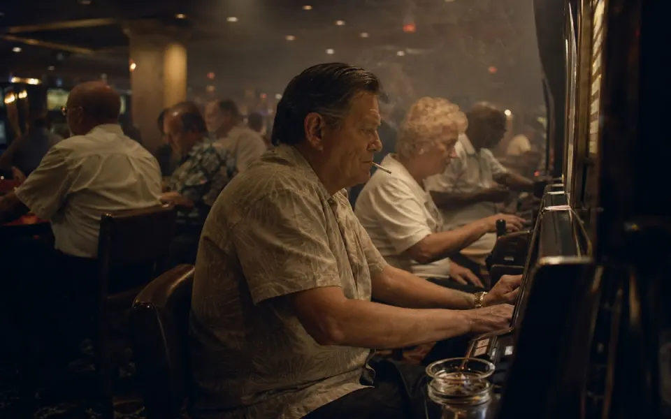 Illustration: a casino floor with cigarette haze in the air and an ashtray on a slot machine ledge