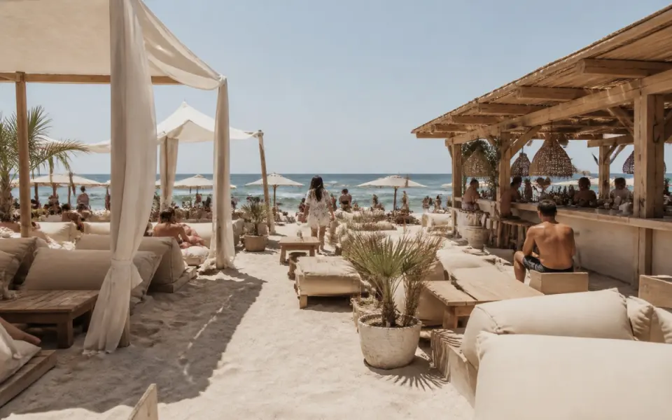 Illustration: an open-air beach club on the sand with white cabanas and low lounge seating